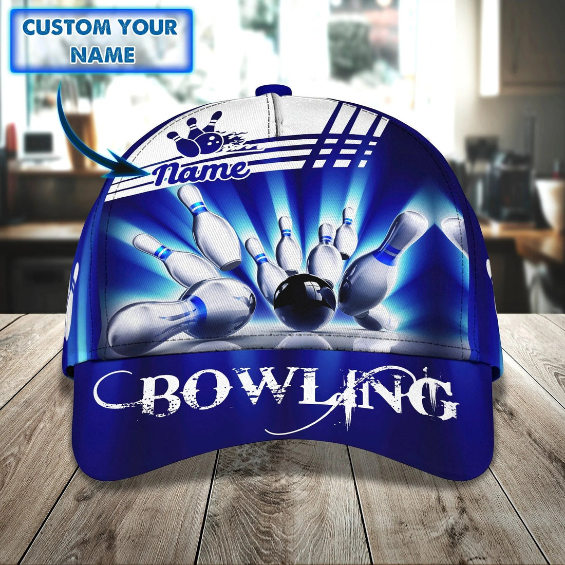 Front view of personalized blue bowling cap showcasing high-contrast bowling pins graphic and custom name area