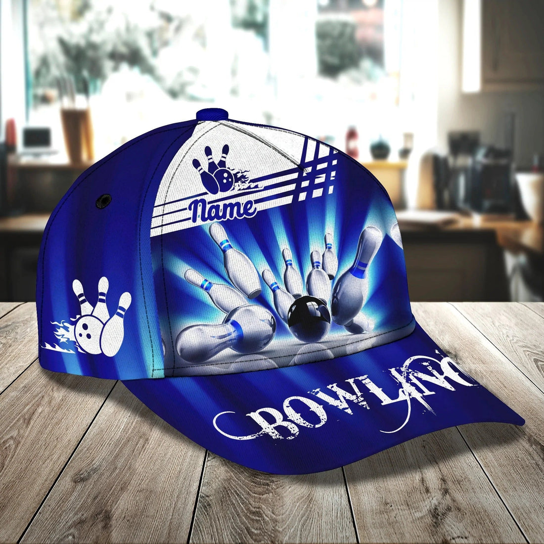 Front view of personalized blue bowling cap showcasing high-contrast bowling pins graphic and custom name area