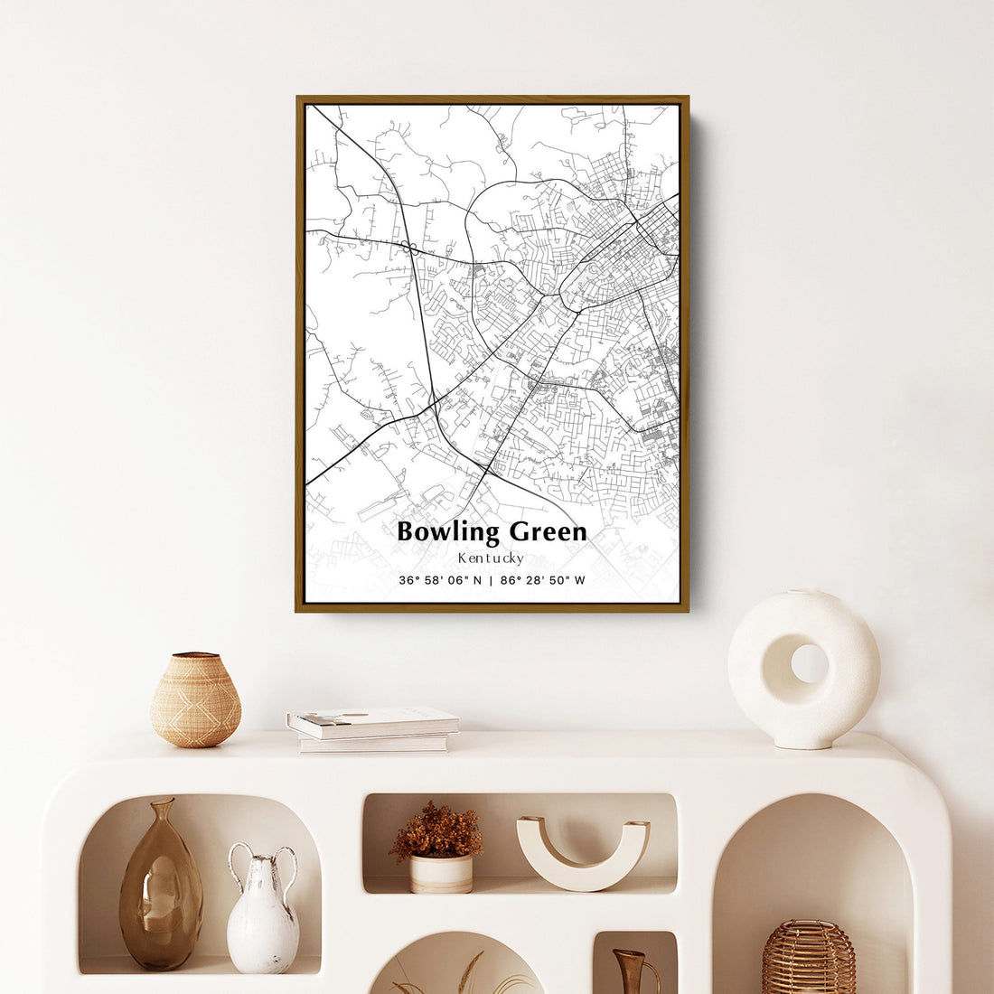 Framed map of Bowling Green, Kentucky hanging on a white wall, showcasing the city's layout in black and white.