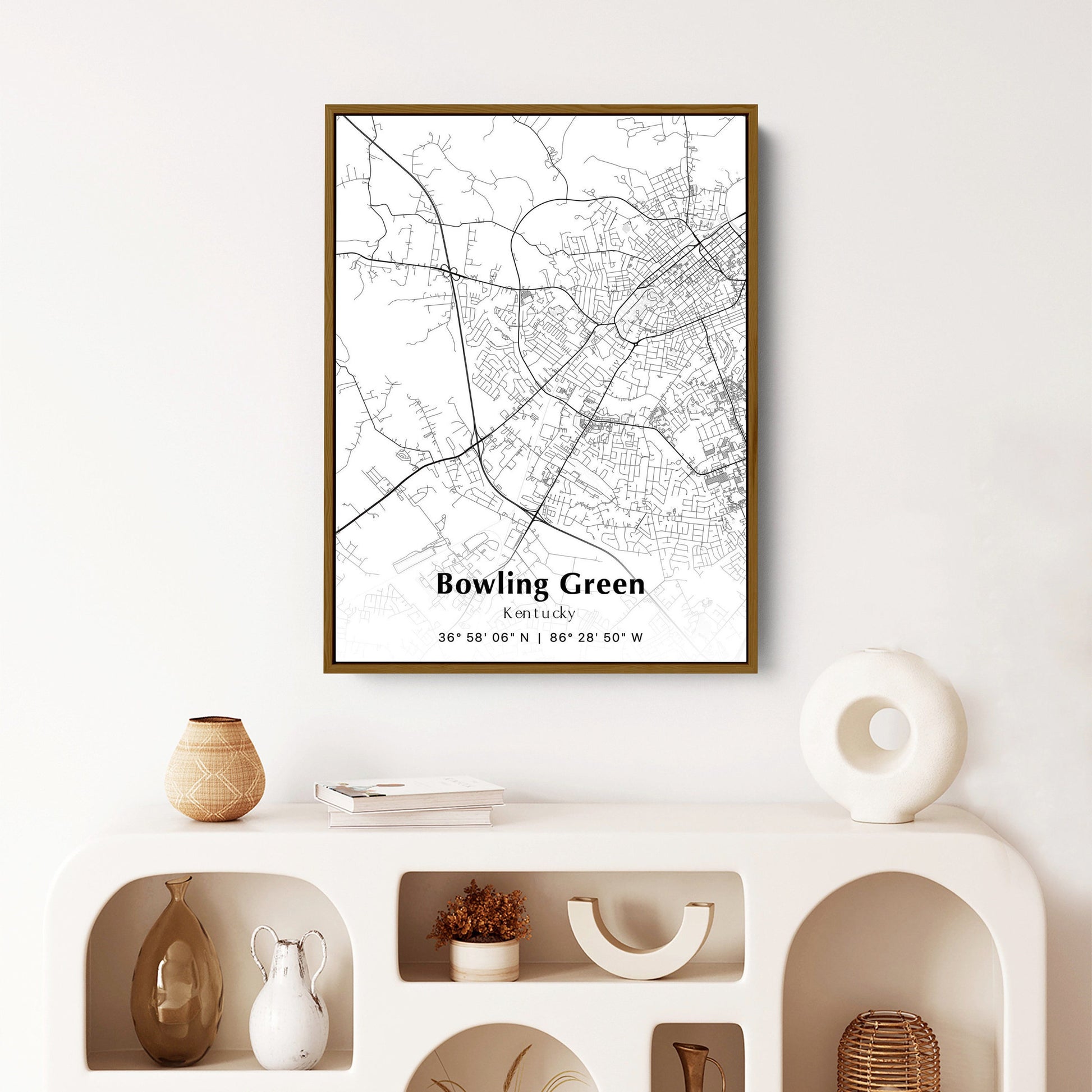 Framed map of Bowling Green, Kentucky hanging on a white wall, showcasing the city's layout in black and white.