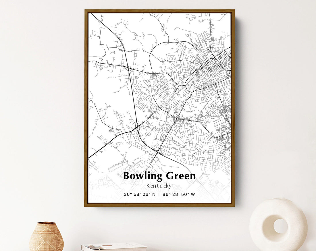 Framed map of Bowling Green, Kentucky hanging on a white wall, showcasing the city's layout in black and white.