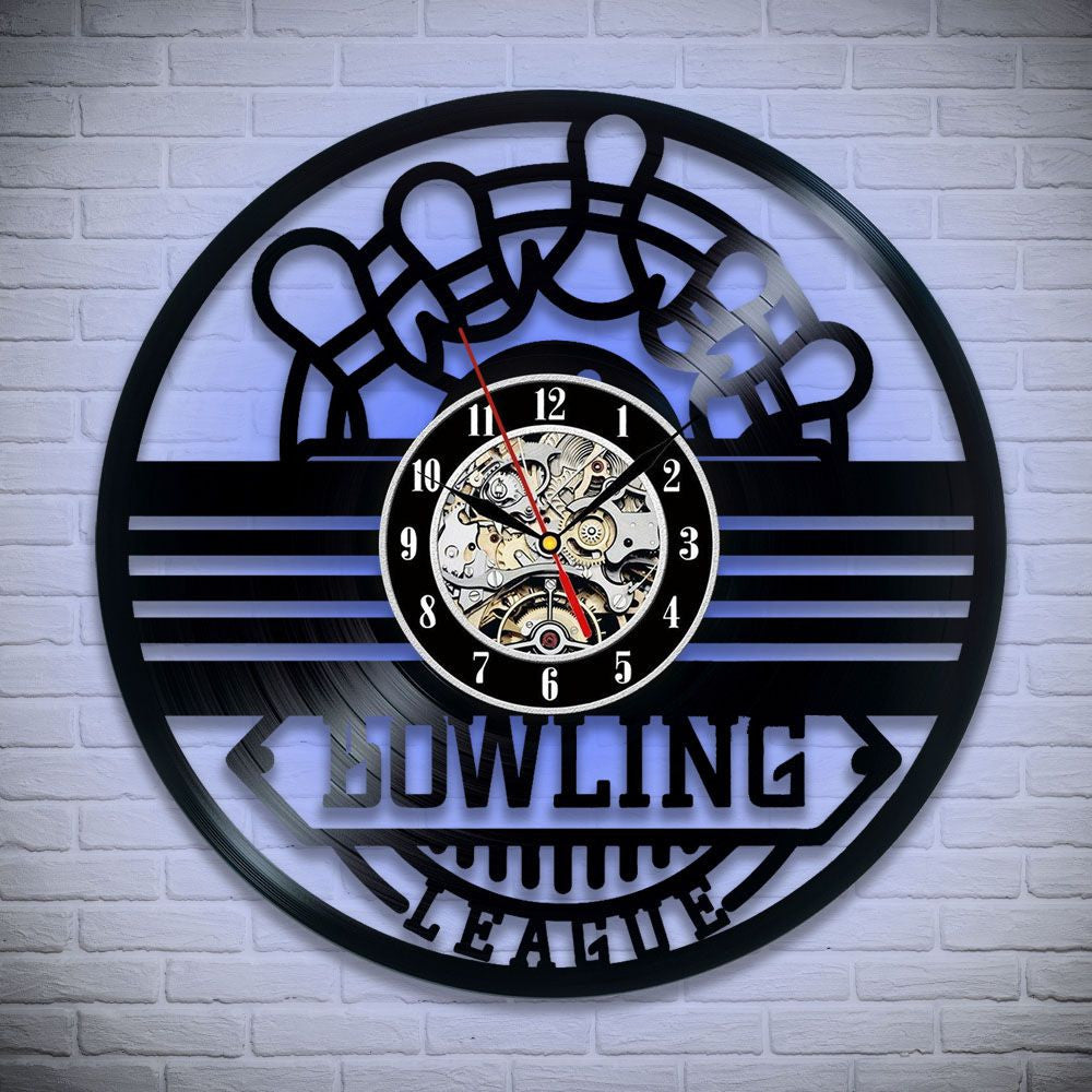Vinyl record wall clock with bowling pins and a bowling ball, featuring the phrase "Let's Bowl" and detailed clockwork mechanism inside.