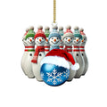 Snowman bowling pin ornament with a blue snowflake and a festive red scarf.