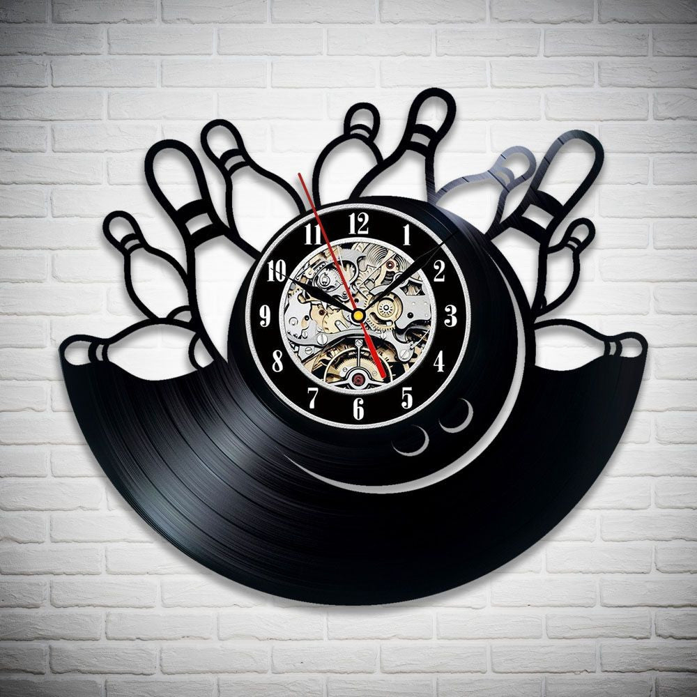 A creative clock made from a vinyl record with bowling pins design. Features mechanical watch details in the center