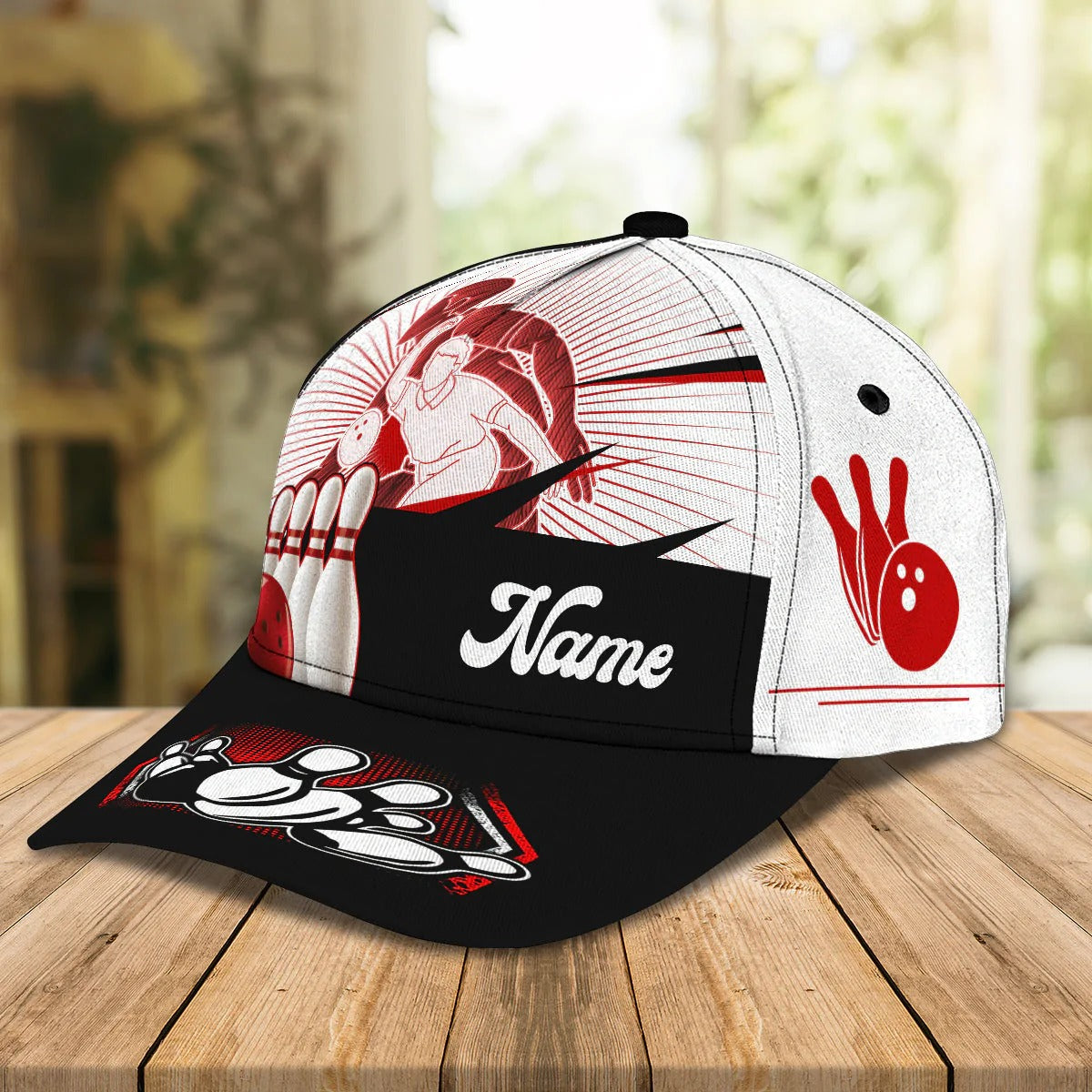 Alt text: “Left side view of baseball cap with red silhouette bowler and pin graphic on white panel”