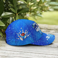 Side-tilt view of blue cosmic bowling cap with exploding pins and red ball graphic against starburst backdrop