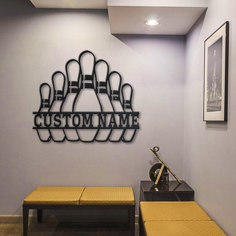 Personalized bowling pin metal sign wall-mounted in a stylish modern hallway with wood bench seating.