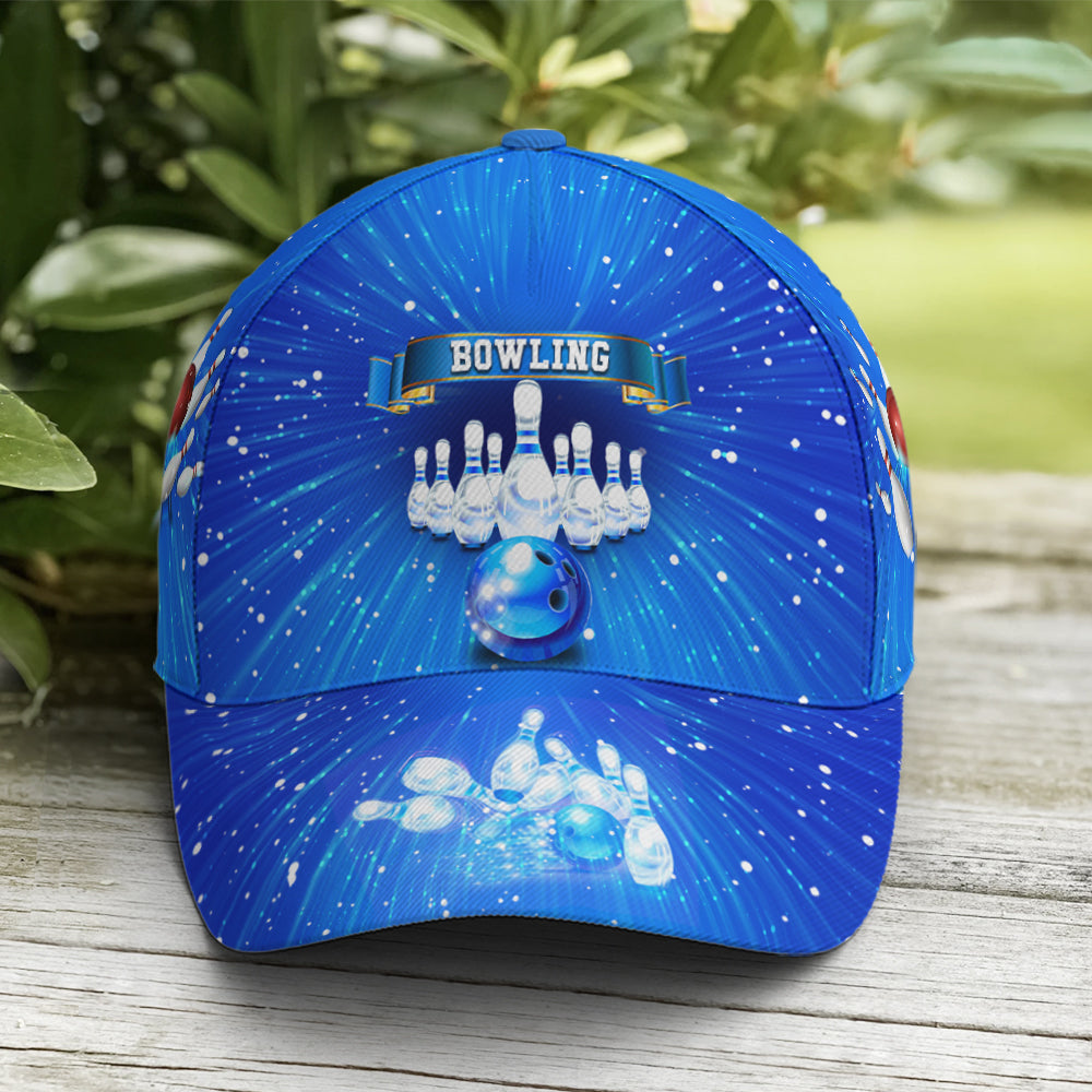 Front view of bowling cap with bold red bowling ball crashing into pins on a radiant blue cosmos background